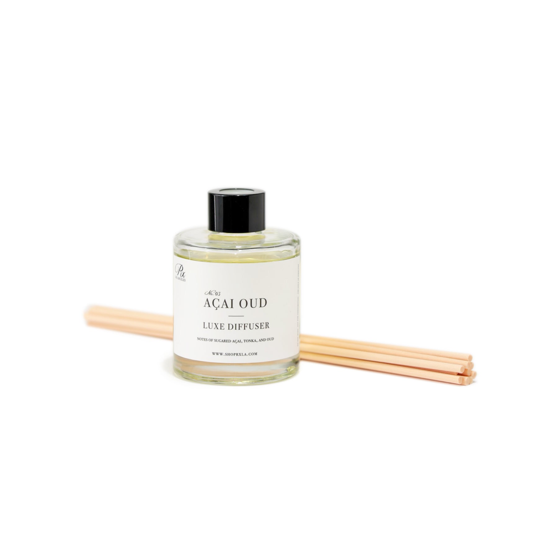 Açai Oud reed diffuser, featuring a luxurious blend of sugared açai, tonka, and oud. This elegant diffuser fills your space with a semi-sweet, woodsy aroma for a warm and exotic ambiance