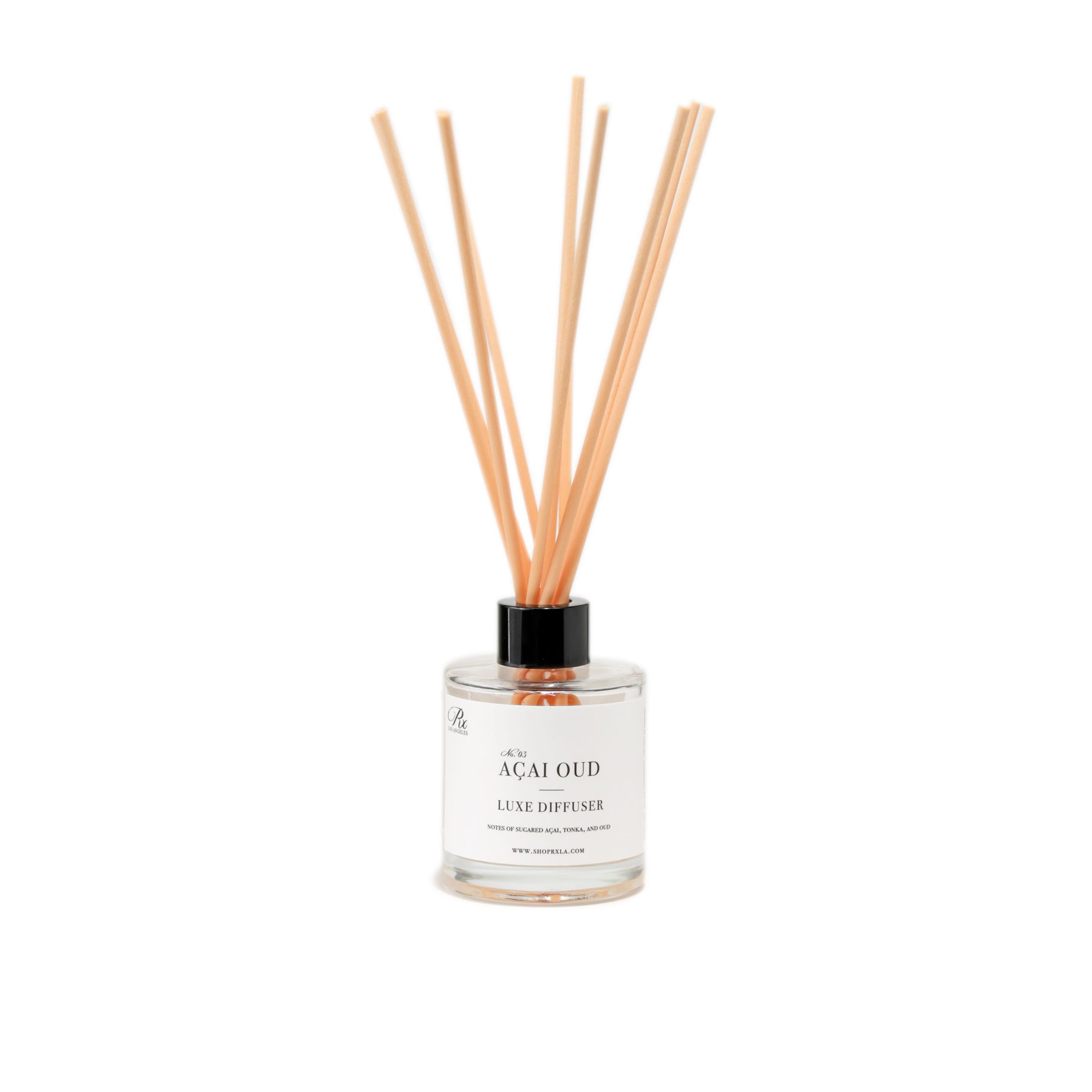 Açai Oud reed diffuser, featuring a luxurious blend of sugared açai, tonka, and oud. This elegant diffuser fills your space with a semi-sweet, woodsy aroma for a warm and exotic ambiance